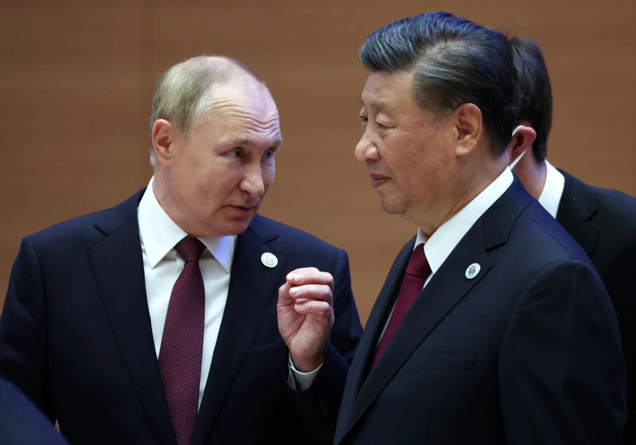 Vladimir Putin y Xi Jinping estrechando manos en una reunión oficial.