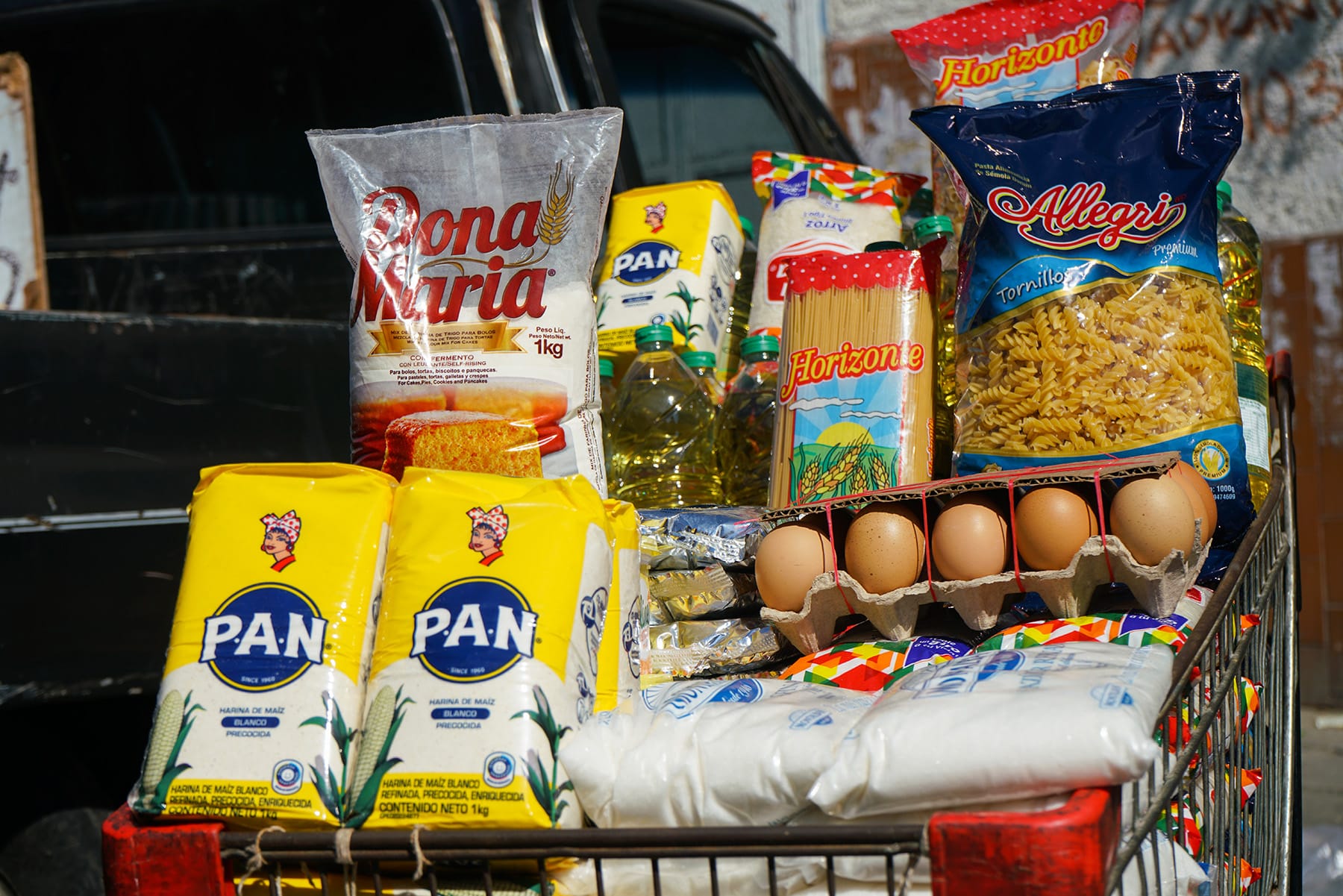 Exhibición de alimentos básicos en un mercado en Venezuela, reflejando altos precios y el desafío para las familias de acceder a ellos.