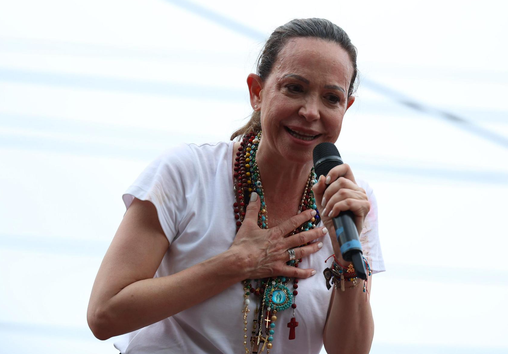 Retrato de María Corina Machado dirigiéndose a una multitud durante un evento político.